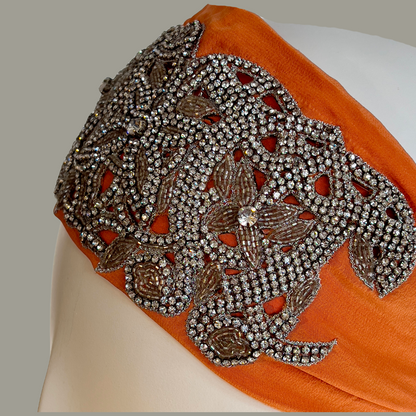 Hand embroidered orange and silver crystal headband with elastic back. 