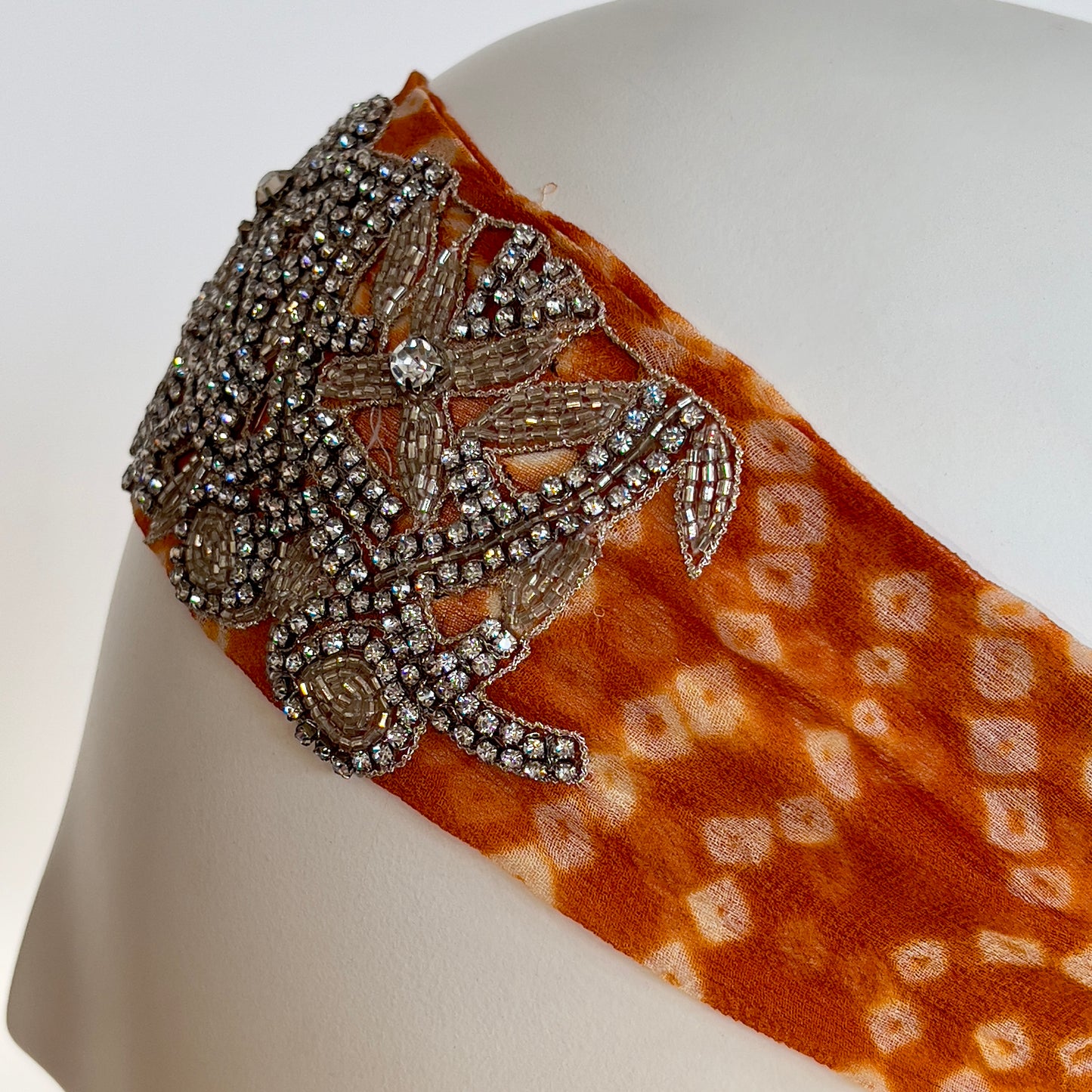 Orange tie-dye headband with crystal embroidery, elastic back