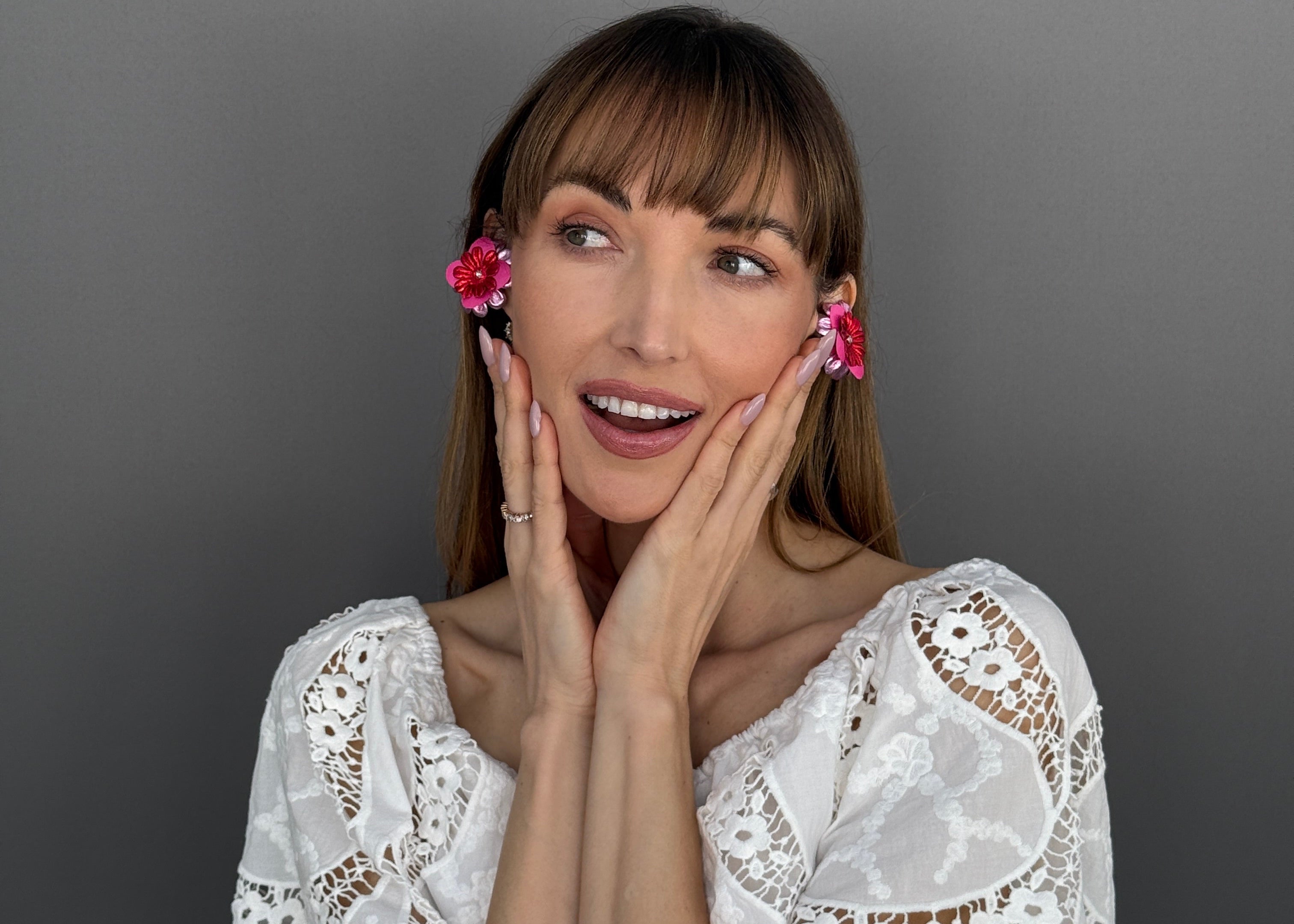 Woman wearing PRIAMBLE floral smart earrings that are earphones by PERIPHERII.