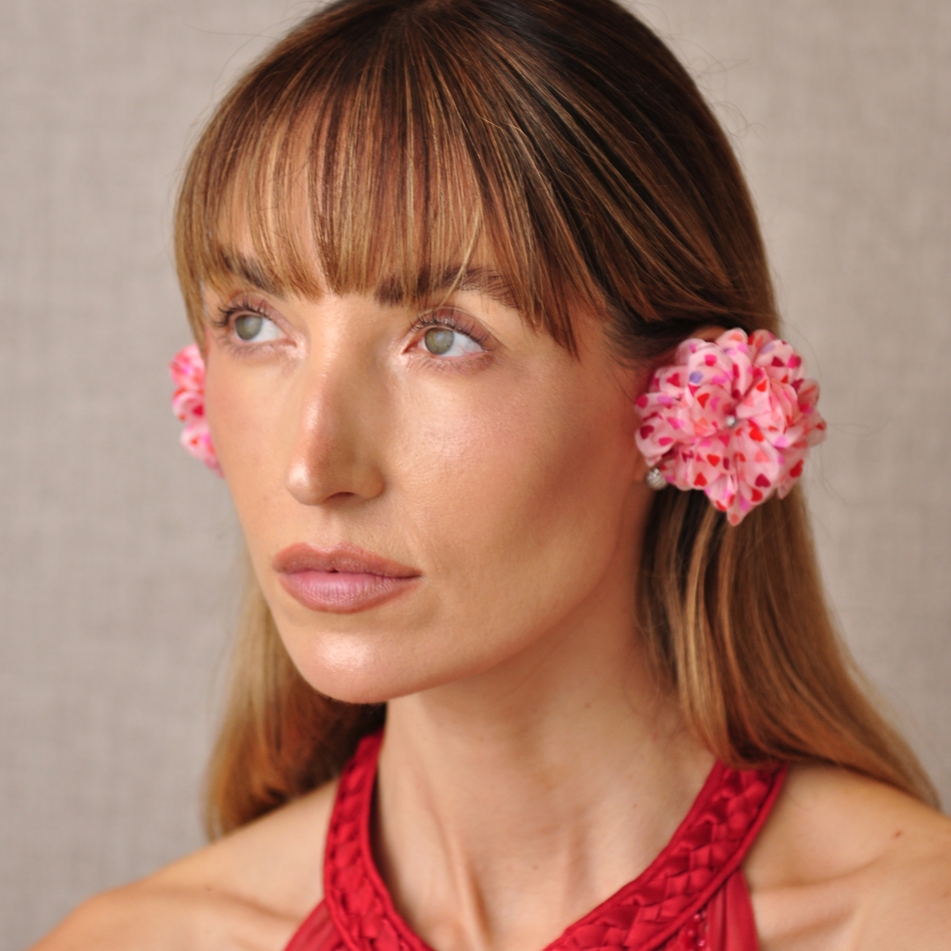 PRIAMBLE™ Blossom Audio Earrings in heart motif worn by a stylish woman – open-ear Bluetooth® earphones by PERIPHERII
