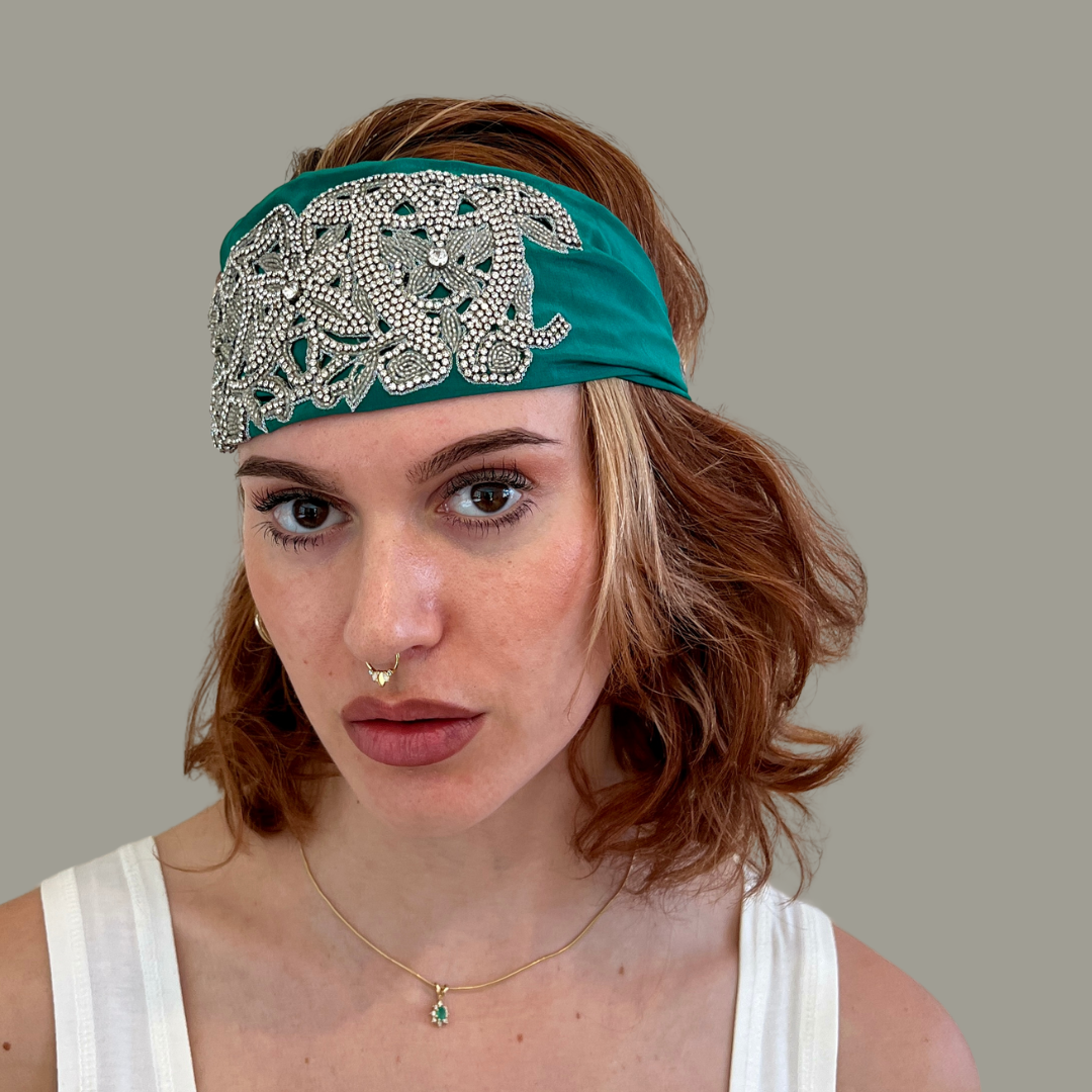 Hand embroidered green and silver crystal headband with elastic back. 