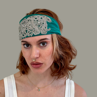 Hand embroidered green and silver crystal headband with elastic back. 