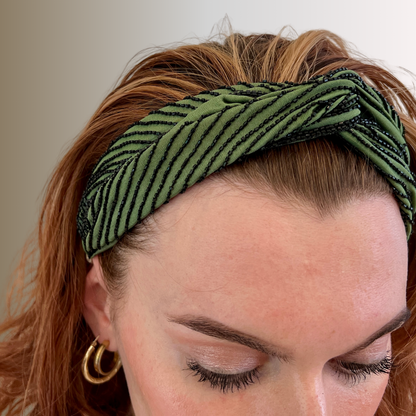 Woman in green headband embroidered in black bugle bead contours by Peripherii